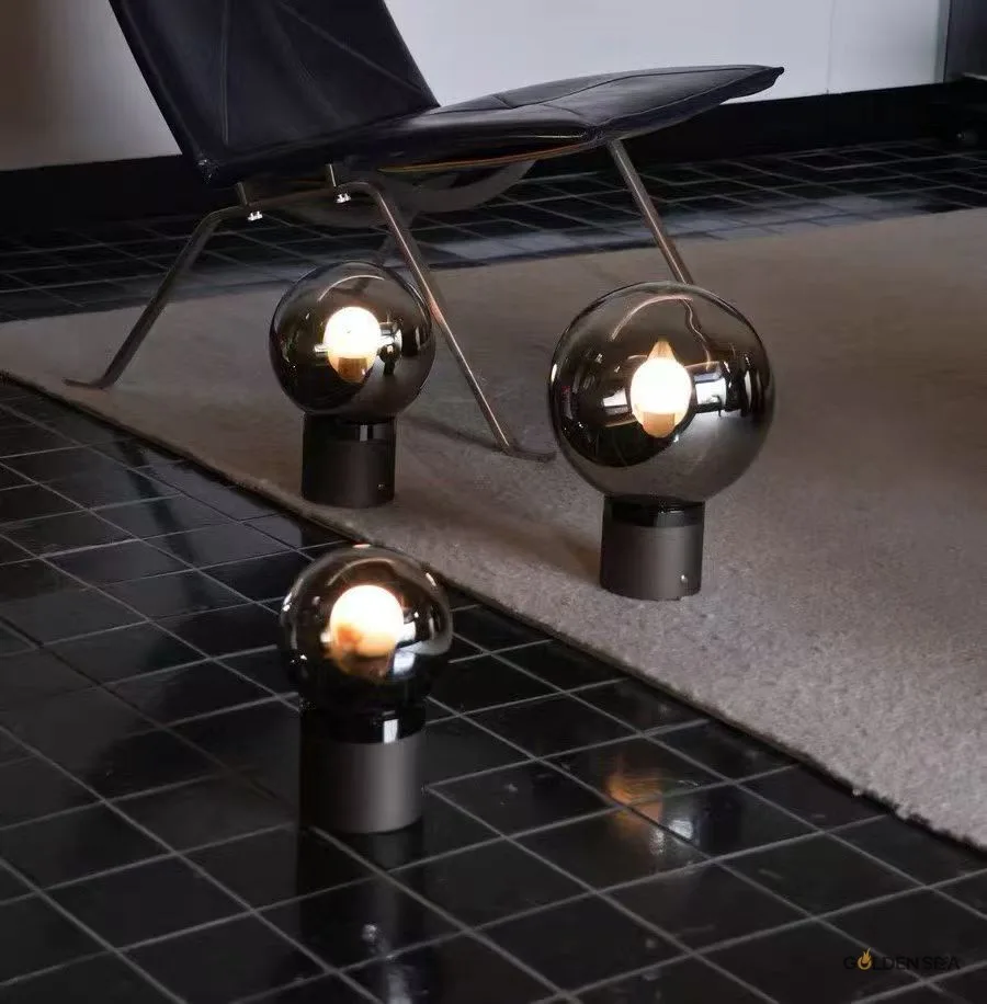 Eclipse smoked glass table lamp with round tinted glass shade and metal base