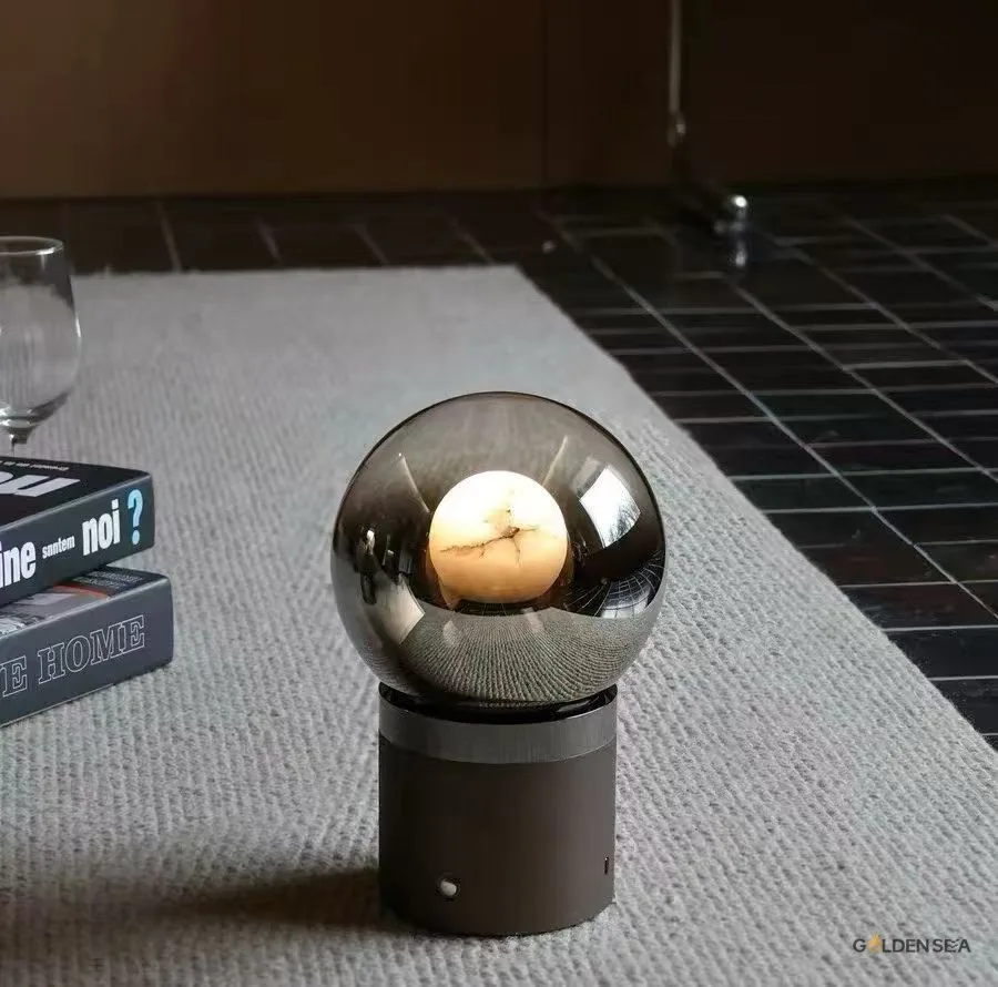 Eclipse smoked glass table lamp with round tinted glass shade and metal base